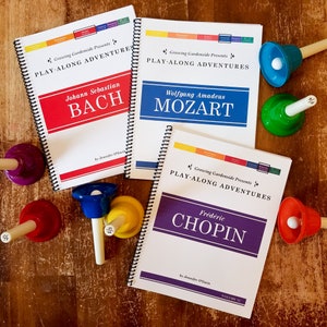 May include: Three spiral bound books with colorful covers titled "Play-Along Adventures" featuring the composers Bach, Mozart, and Chopin. The books are accompanied by colorful jingle bells.