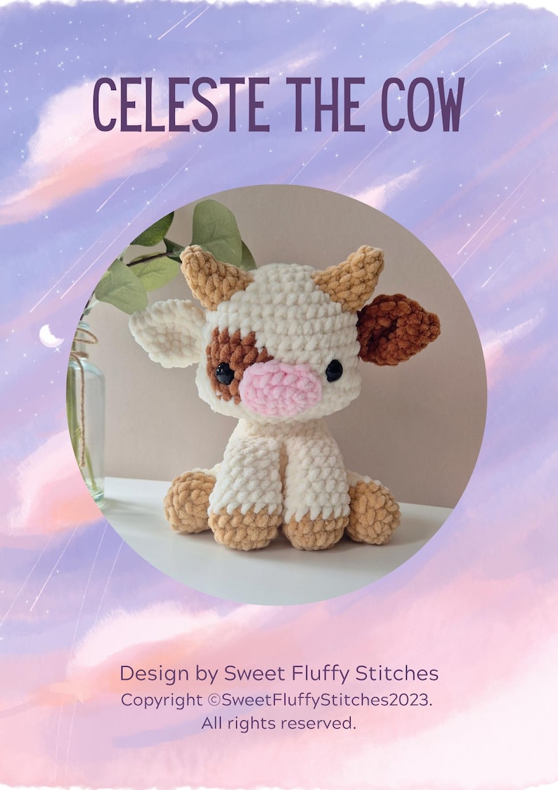 May include: A crocheted plush toy cow named Celeste. The cow is white with brown spots and has a pink nose. The cow is sitting on a white surface.