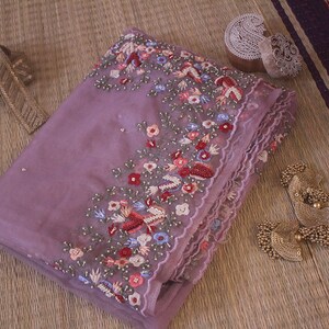 Folded saree view highlighting organza silk texture and embroidery