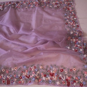 Close up of hand embroidery on organza silk fabric