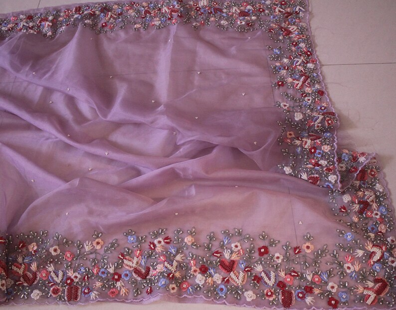 Close up of hand embroidery on organza silk fabric
