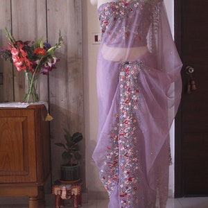 Pallu view showing delicate hand embroidery on lilac organza silk