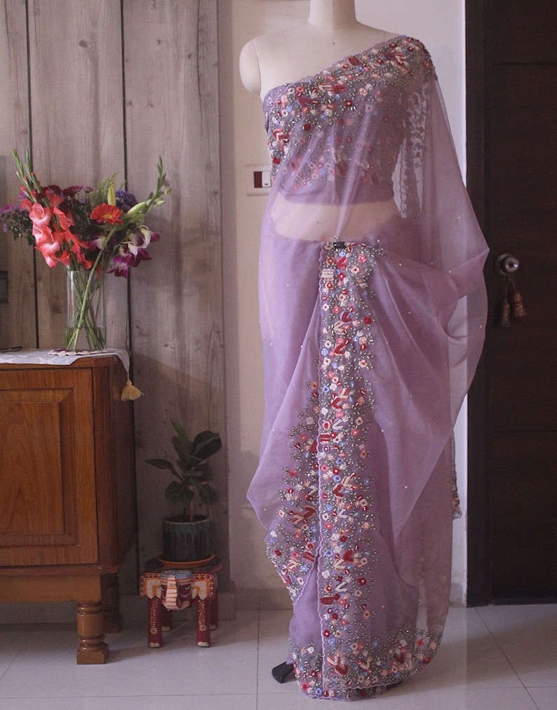 Pallu view showing delicate hand embroidery on lilac organza silk