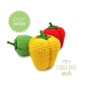May include: Three crocheted bell peppers, one red, one yellow, and one green. The peppers are arranged in a row, with the red pepper in the back and the yellow pepper in the front. The text "RIBBED AND smooth" is written below the peppers.