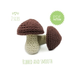 Può includere: Due funghi all'uncinetto, uno con un cappello marrone a coste e l'altro con un cappello marrone liscio. Entrambi i funghi hanno un gambo color crema. L'immagine include il testo "PDF PATTERN" e "2 SIZES".