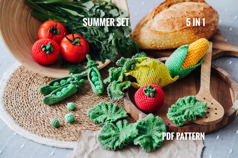 May include: A crochet summer set of vegetables, including a corn on the cob, tomato, lettuce, and peas. The set is displayed on a wooden tray with a wooden spoon. The text "SUMMER SET" and "5 IN 1" are visible in the image. The text "PDF PATTERN" is also visible in the image.