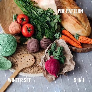May include: A crochet winter vegetable set with five pieces: a cabbage, a beet, two carrots, and an onion. The set is displayed on a wooden tray with a loaf of bread and fresh herbs. The text "PDF PATTERN" and "WINTER SET" are visible in the image. The text "5 IN 1" is also visible in the image.