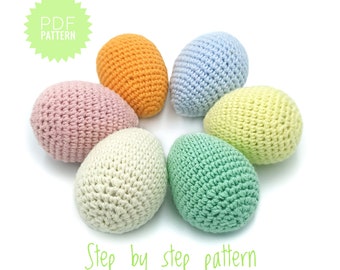 May include: Six crocheted Easter eggs in a circle, in pastel colors: pink, orange, light blue, yellow, cream, and green.  The text "Step by step pattern" is written below the eggs.