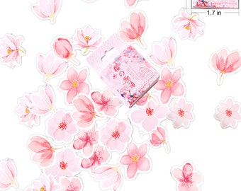 May include: A sheet of pink and white floral stickers with a small box of stickers in the center. The box has Japanese text that reads "桜の物语" which translates to "Cherry Blossom Story".
