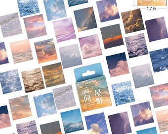 May include: A sheet of 40 sky and ocean themed stickers. The stickers are 1.7 inches square and feature a variety of blue, pink, and orange colors. The stickers are packaged in a small blue box with the text "云间 星野" in Japanese.