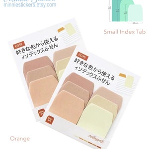 Puede incluir: Dos paquetes de 60 pesta&ntilde;as de &iacute;ndice redondeadas de color melocot&oacute;n, beige y amarillo claro. Las pesta&ntilde;as est&aacute;n etiquetadas con "60枚 好きな色から使える インデックスふせん", que se traduce como "60 piezas, puedes usar tu color favorito, pesta&ntilde;as de &iacute;ndice". Los paquetes est&aacute;n etiquetados con "Orange" y "ookmarks".