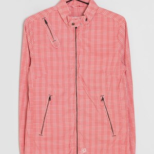 May include: A red and white checkered jacket with a full-length zipper and two front pockets. The jacket has a small collar and a zipper pocket on the left chest. It is hanging on a black hanger.