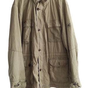 May include: A light brown utility jacket with multiple pockets and a button closure.