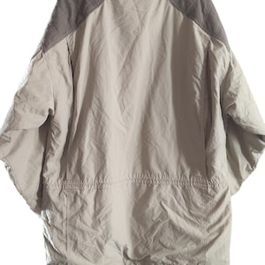 May include: A beige and brown hooded jacket with a zipper closure and a drawstring at the waist.