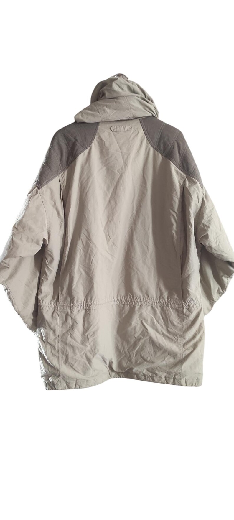 May include: A beige and brown hooded jacket with a zipper closure and a drawstring at the waist.