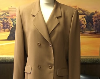 May include: A brown double-breasted blazer and matching skirt suit. The blazer has a notched lapel and two button fastenings. The skirt is knee-length.