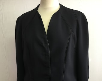 May include: A black blazer with a v-neck and a single button closure. The blazer has a tailored fit and features a subtle sheen.
