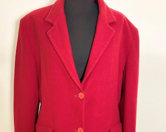 May include: A red blazer with a single-breasted closure and two button pockets. The blazer has three buttons and a notched collar.