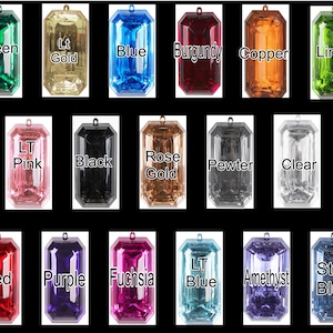 May include: Assortment of 18 emerald-shaped plastic charms in various colors, including green, gold, blue, burgundy, copper, lime, pink, black, rose gold, pewter, clear, red, purple, fuchsia, amethyst, and steel blue.