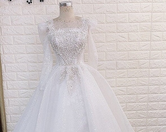 White princess wedding dress with long sleeves and corset/lace up back, beaded princess snow white bridal gown