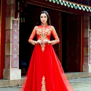 Stunning traditional Vietnamese wedding ao dai in red with gold lace details, option to order with dark blue men's ao dai with gold details