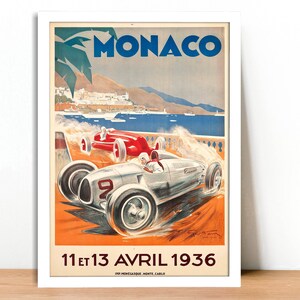 May include: Vintage poster advertising the Monaco Grand Prix, featuring a white and silver race car speeding along a coastal road with a blue ocean and a palm tree in the background. The poster text reads "MONACO" and "11 et 13 AVRIL 1936".