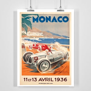 May include: Vintage poster advertising the Monaco Grand Prix, featuring two racing cars speeding along a coastal road. The poster is in a retro style with a blue sky, palm trees, and the text "MONACO" in large, bold letters. The date "11 et 13 AVRIL 1936" is printed at the bottom.