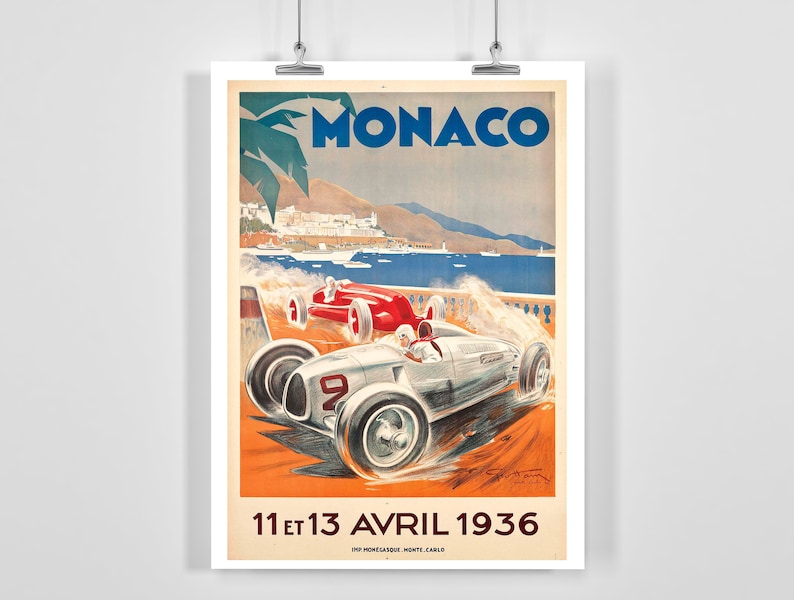 May include: Vintage poster advertising the Monaco Grand Prix, featuring two racing cars speeding along a coastal road. The poster is in a retro style with a blue sky, palm trees, and the text "MONACO" in large, bold letters. The date "11 et 13 AVRIL 1936" is printed at the bottom.