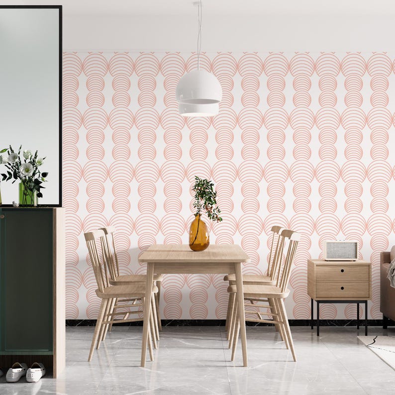 May include: A dining room with a white wall featuring a pink geometric pattern wallpaper. A wooden table with four chairs is in the center of the room. A white pendant light hangs above the table.