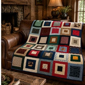May include: A patchwork quilt featuring a grid of square blocks in various colors and patterns, including red, blue, green, and tan. The quilt displays a repeating frame design around each central square, with some blocks showcasing small bear motifs.