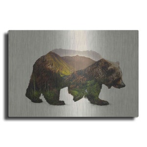 May include: A brown bear silhouette with a forest scene overlayed on a brushed metal background.
