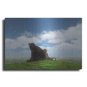 May include: A brown bear and a person sit side-by-side on a grassy hill, looking up at a cloudy sky. The bear is on the left, and the person is on the right. The sky is a light blue with white clouds.