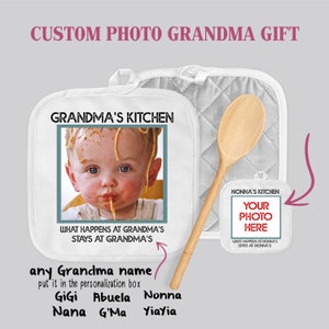 May include: White pot holder with the text "Grandma's Kitchen" and a photo of a baby eating spaghetti. The pot holder has a white quilted design. The text "What happens at Grandma's stays at Grandma's" is printed below the photo. A wooden spoon is included.