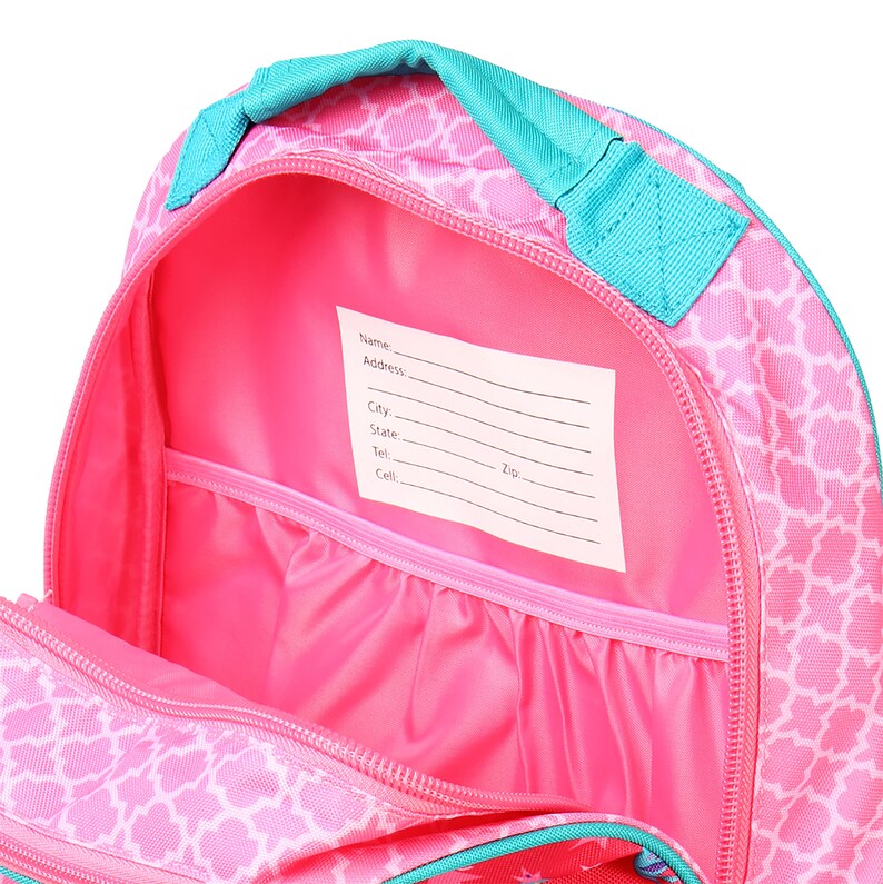 May include: Pink backpack with a turquoise zipper and handle. The inside of the backpack has a pink lining and a white label with the words "Name", "Address", "City", "State", "Tel", "Cell", and "Zip".