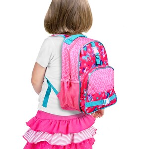 May include: A pink and blue backpack with a unicorn and horse print. The backpack has a mesh pocket on the side and a front pocket with a buckle.