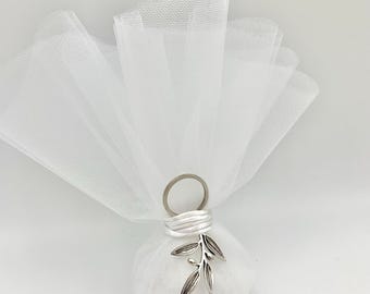 May include: White tulle favor bag with a silver olive branch charm. The bag is tied with a white ribbon and has a silver ring at the top.