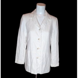 May include: A white linen blazer with a button-up front and long sleeves.