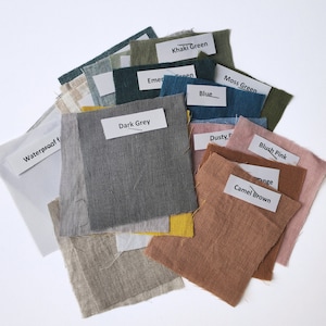 May include: A collection of fabric swatches in various colors, including khaki green, moss green, blue, dusty pink, blush pink, camel brown, dark grey, and emerald green. The swatches are labeled with their corresponding colors. The text "easy linen CRAFTS" is visible at the bottom of the image.