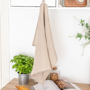 an open book on a table next to a potted plant