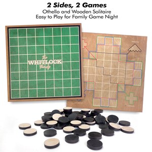 May include: A wooden board game set with two game boards and game pieces. One board is green with a grid, the other is light brown with a geometric design. The text "2 Sides, 2 Games" and "The Whitlock Family" are visible.