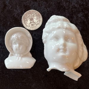 One perfect condition Antique Porcelain Doll Head and One Broken Doll Face.