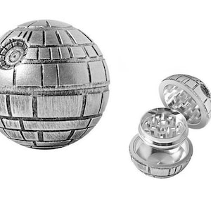May include: A silver metal grinder shaped like the Death Star from Star Wars. The grinder is open, revealing the grinding mechanism inside.
