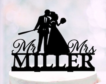 May include: Black silhouette of a bride and groom kissing with a baseball bat and ball. The text "Mr. & Mrs. Miller" is below the couple.