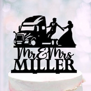 May include: Black silhouette cake topper featuring a bride and groom holding hands and standing on a semi-truck. The text "Mr & Mrs MILLER" is below the truck.