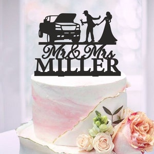 May include: Black silhouette cake topper featuring a couple, a truck, and the text "Mr. & Mrs. MILLER".