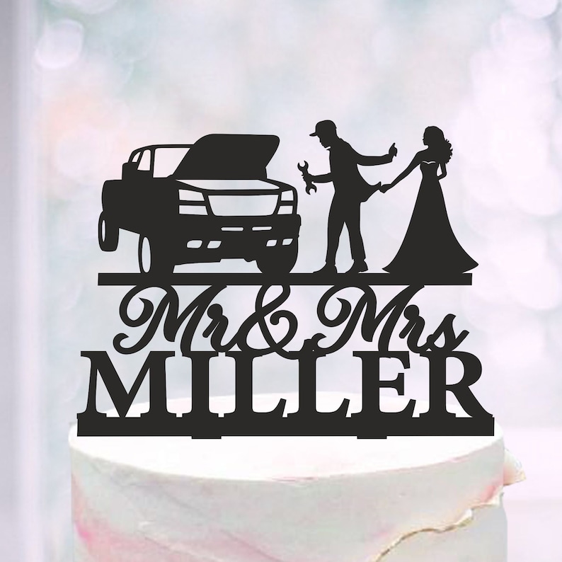 May include: Black silhouette cake topper featuring a couple, a truck, and the text "Mr. & Mrs. Miller".