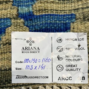 May include: A white tag with black text that reads "ARIANA RUGS DIRECT" and includes information about the rug's size, code, and material. The tag also includes the text "HANDMADE", "100% WOOL", "NATURAL COLOURS", "GREAT QUALITY", "ARIANARUGSDIRECT.COM", and "ARCC".