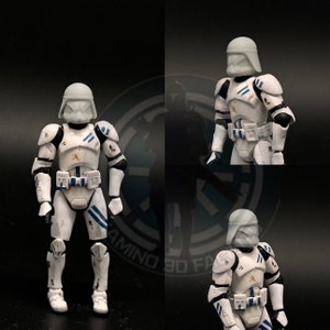 May include: Three white and blue Star Wars clone trooper action figures with weathered paint. The figures are wearing helmets and have blue and white markings on their armor.
