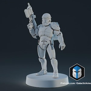 May include: A light gray action figure of a futuristic soldier, holding a blaster gun. The figure is wearing detailed armor and a helmet. It stands on a white circular base. The Galactic Armory logo is visible.
