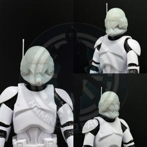 May include: Four images of a white and black action figure in a military-style uniform with a helmet and antenna. The figure has white armour plating and black undersuit details. The helmet is light grey. The background is dark with a logo.